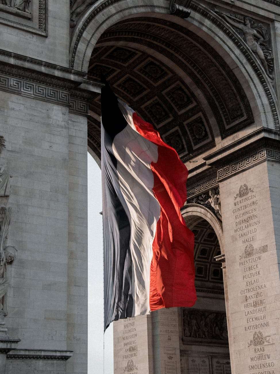 triumphal arch decorated with flag of france