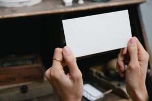 crop unrecognizable woman showing blank card