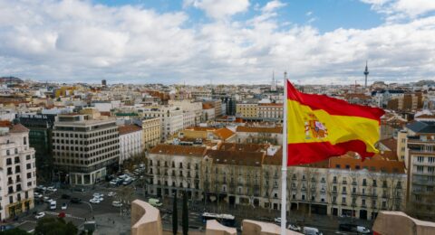 spanish national flag against cityscape