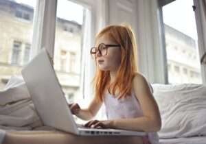 a girl watching movie on computer laptop